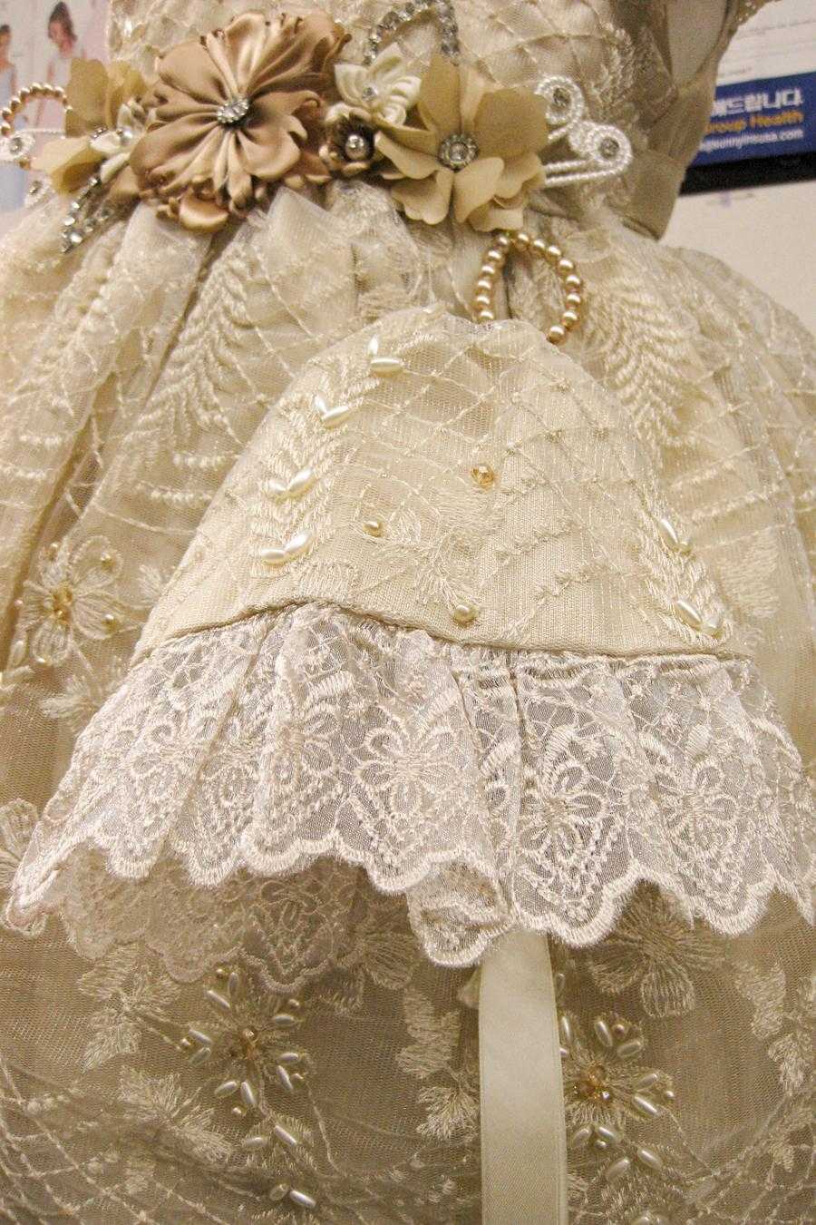 Girl's dark ivory baptism fabric texture and pearl beading