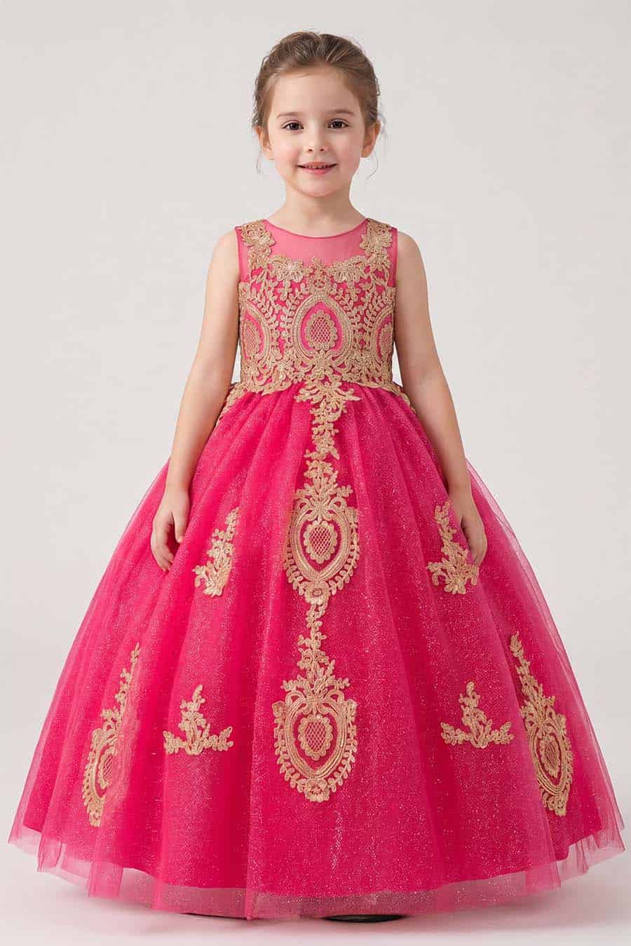 Girls fuchsia ball gown with gold embroidered appliqués, glitter tulle skirt, keyhole back, and lace-up corset closure shown from front